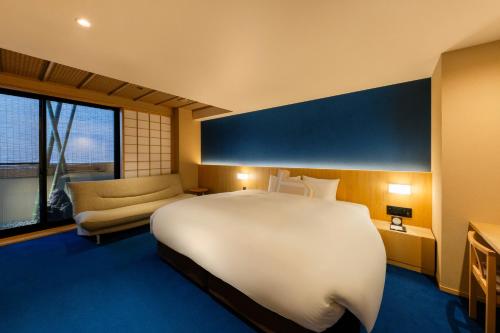 Postel nebo postele na pokoji v ubytování Homm Stay Nagi Shijo Kyoto By Banyan Group