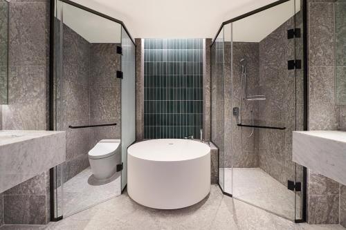 a bathroom with a toilet and a shower and a sink at Naru Ambassador Hotel Seoul - MGallery Collection in Seoul