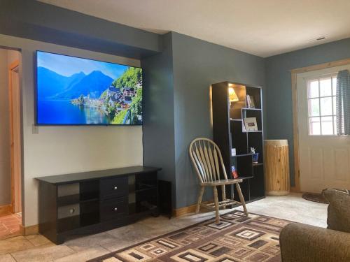 a living room with a flat screen tv on the wall at InnSpiration Escalante - Premium Vacation Rental 3-5 Beds in Escalante