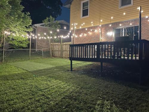 a yard with a bench in front of a house with lights at Family Retreat Get Away in Decatur