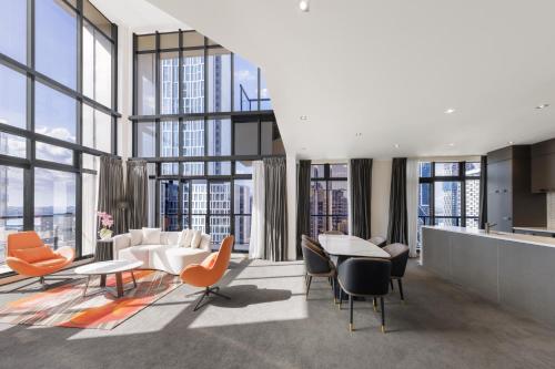 a rendering of a living room with furniture and windows at Adina Citylife Auckland in Auckland