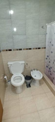 a bathroom with a toilet and a bidet at Las Costas - Tu descanso in Cañuelas