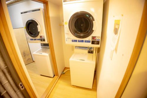 a washing machine and a washer and dryer in a room at Onsen & Garden -Asante Inn- in Hakone