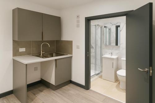a small bathroom with a sink and a toilet at 133 Wood Green Studios to Central London in London