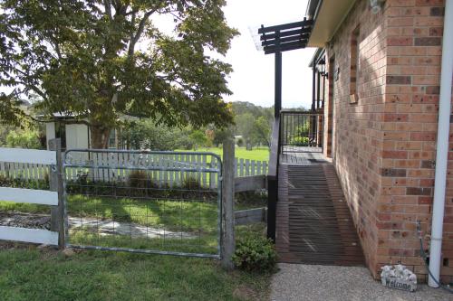 a gate to a house with a fence at Bryn Glas Farm Stay in Moruya