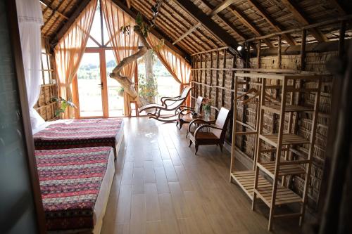 a room with a room with bookshelves and a room with a room at Upes Garden Homestay Bien Ho in Bien Ho