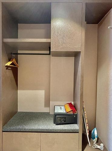 a walk in closet with a radio in it at D ELEGANCE GRAND BANDAR SERI ALAM in Masai