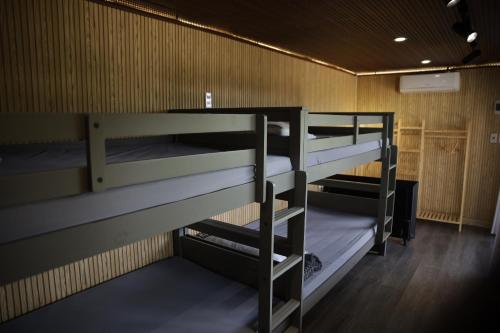 a room with three bunk beds in it at Upes Garden Homestay Bien Ho in Bien Ho