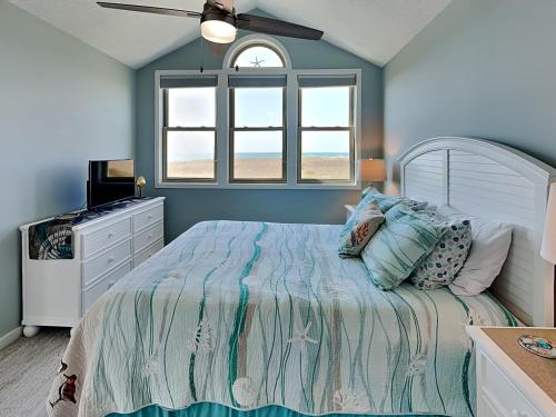 a bedroom with a bed and a window at Slow Motion #8A in Topsail Beach