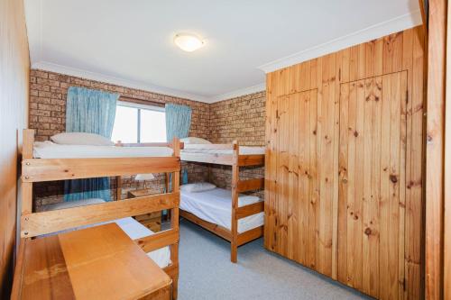 ジンダバインにあるAviemore - 2 14 Cobbodah Streetの二段ベッド2組、窓が備わるドミトリールームです。
