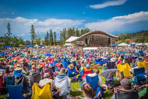 a large crowd of people sitting in chairs at a concert at Skyview in Fraser