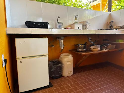 a small kitchen with a refrigerator and a counter at A Piece of Paradise in San Carlos