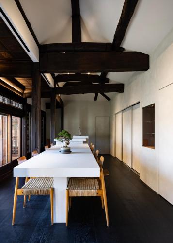 a large dining room with a white table and chairs at Nostalgia Hanok Hotel in Seoul