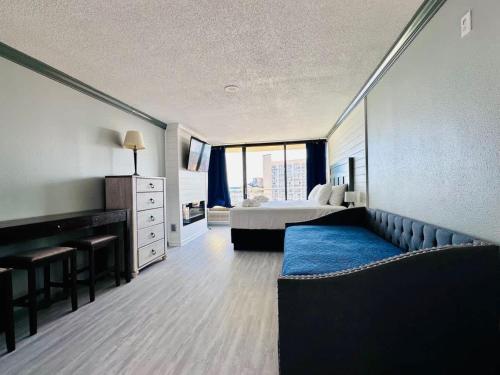 a hotel room with a bed and a couch at Lovely Beach View Condo,King,Pool,M11 in Myrtle Beach