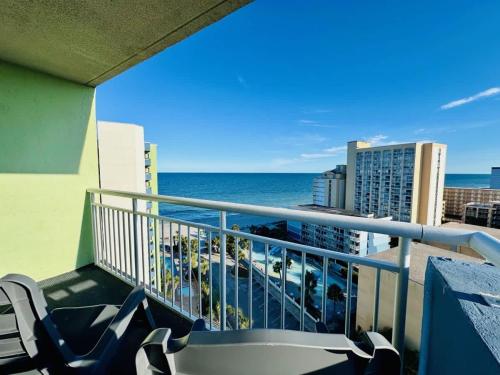 a balcony with chairs and a view of the ocean at Lovely Beach View Condo,King,Pool,M11 in Myrtle Beach