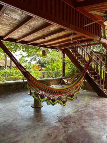 a hammock hanging from the ceiling of a building at A Piece of Paradise in San Carlos