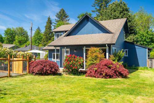 a blue house with a yard at Delightful family-friendly home in the heart of WA in Olympia