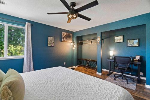 a bedroom with blue walls and a ceiling fan at Delightful family-friendly home in the heart of WA in Olympia