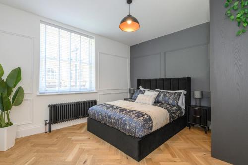 a bedroom with a bed and a large window at Paradise Boutique Deluxe - Leeds City Center - Steps to Ivy Asia in Leeds