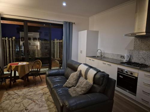 a living room with a couch and a kitchen at Pemberton Japanese Garden Studio 2025 Winner Travellers Award in Pemberton