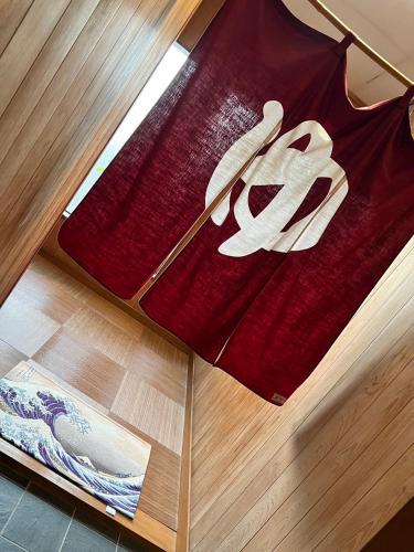 a red shirt on top of a wooden floor at Onsen & Garden -Asante Inn- in Hakone