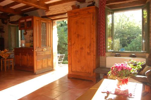 a living room with a table and some windows at Le Mas des Clots in Upie
