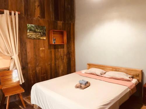 a bedroom with a bed with a stuffed elephant on it at Ba Danh Homestay & Kitchen - Ben Tre Mekong in Ben Tre