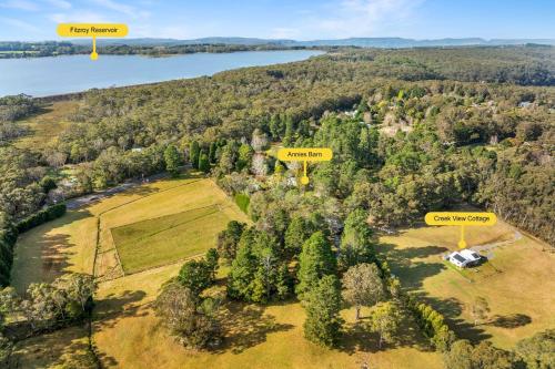 an aerial view of an estate with trees and a lake at Annies Barn, Fitzroy Falls in Fitzroy Falls