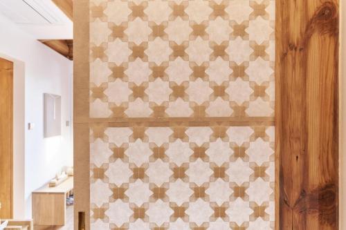 a room with a wall with a pattern on it at Nostalgia Hanok Hotel in Seoul