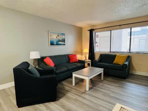 a living room with two couches and a table at *A FAMILY GETAWAY*Pool*Steps to the Beach*Approved Dogs*D18 in Myrtle Beach