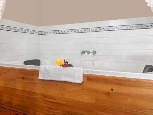 a bath tub in a bathroom with a wooden floor at Montville Boutique BnB in Montville
