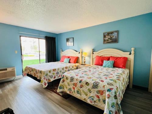 two beds in a room with blue walls at *A FAMILY RETREAT*Pool*Steps to the Beach*Approved Dogs*D18-9 in Myrtle Beach