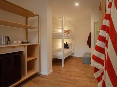 a room with a bedroom with a bed in it at Little Drifter Canberra in Canberra