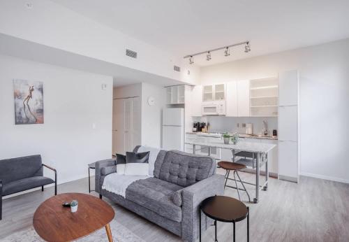 a living room with a couch and a table at CozySuites Sky Central #3 in Cincinnati