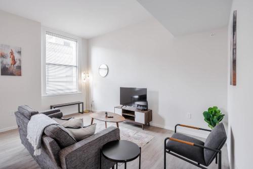 a living room with a couch and a table at CozySuites Sky Central #3 in Cincinnati