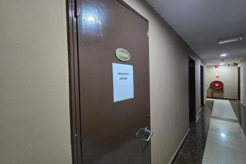 a door in a hallway with a sign on it at Fast Hotel Melaka Near Menara Taming Sari - 2 Mins Only in Melaka