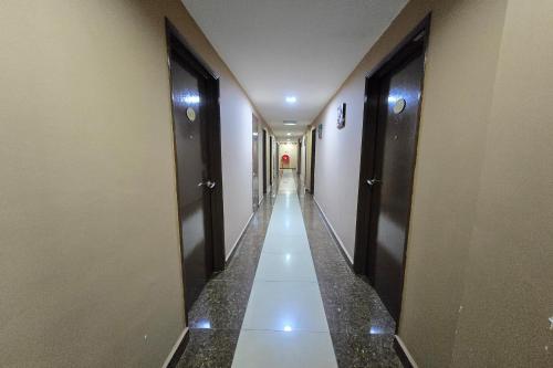 a hallway with two doors and a long corridor at Fast Hotel Melaka Near Menara Taming Sari - 2 Mins Only in Melaka