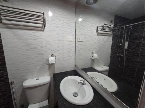 a bathroom with a sink and a toilet and a shower at Fast Hotel Melaka Near Menara Taming Sari - 2 Mins Only in Melaka
