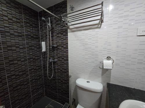 a bathroom with a shower and a toilet and a sink at Fast Hotel Melaka Near Menara Taming Sari - 2 Mins Only in Melaka