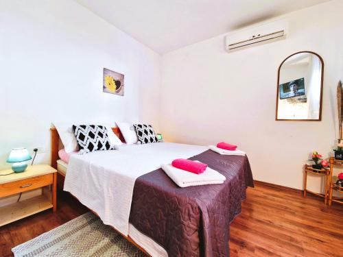 a bedroom with a bed and a mirror at Comfortable Rooms - City Place in Split
