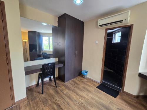 a room with a desk with a chair and a mirror at Fast Hotel Melaka Near Menara Taming Sari - 2 Mins Only in Melaka