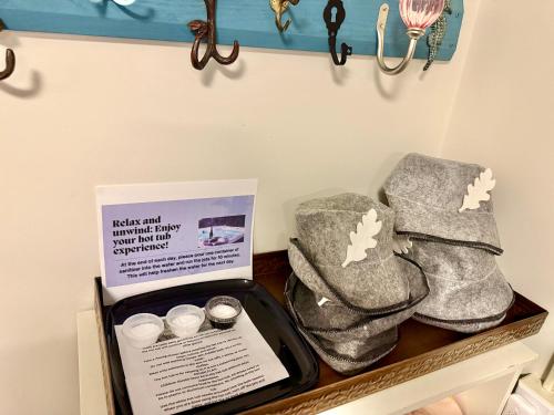a shelf with two pairs of snow boots and a sign at Poconos Getaway with Hot Tub-Close to Attractions, Perfect for Family &Friends! in Blakeslee