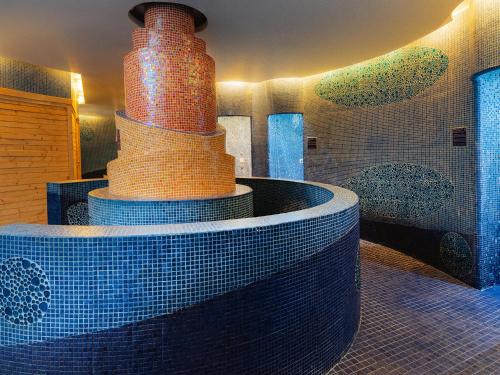 a room with a tub with two vases on top at Grand Sirenis Riviera Maya Resort & Spa All Inclusive in Akumal