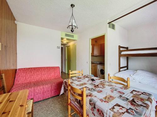 une chambre avec un lit, un bureau et une table dans l'établissement Studio 4 pers au pied des pistes avec balcon à La Toussuire - FR-1-416-236, à La Toussuire