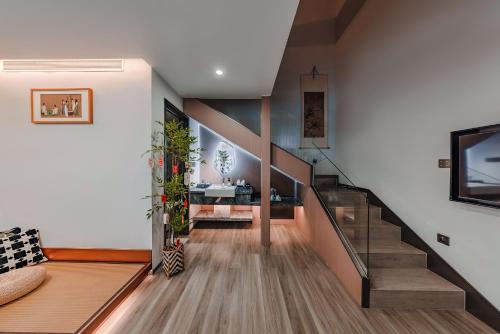 a staircase in a house with a living room at Lishè Hotel in Pingyao