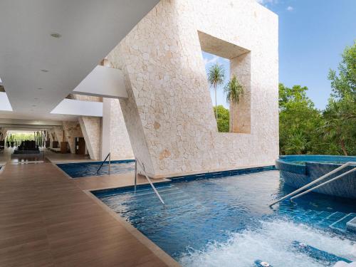 a swimming pool in the middle of a building at Grand Sirenis Riviera Maya Resort & Spa All Inclusive in Akumal