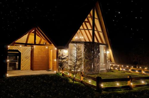 a house with lights on the side of it at night at Cabañas Nevados Del Valle in Malalcahuello