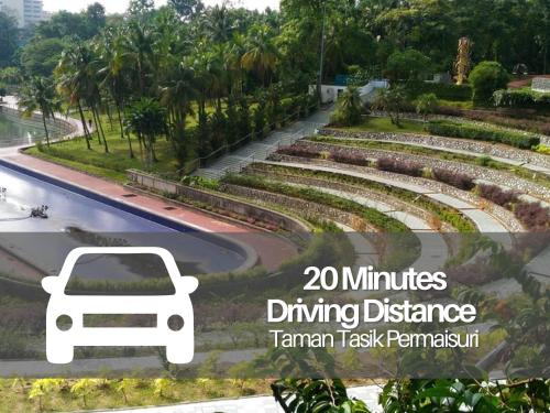 a park with a white car driving down a road at Smile Hotel C180 Cheras Selatan in Cheras