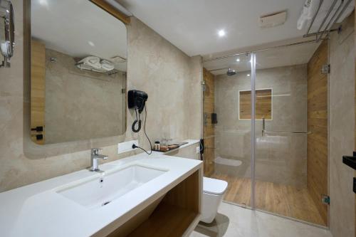a bathroom with a sink and a toilet and a shower at Lago Leisure Resort & Spa in Cherai Beach