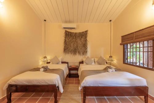 Postel nebo postele na pokoji v ubytování Canaan Beach Resort